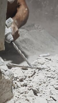 Worker Using Rotary Hammer Drill to Break Concrete Surface