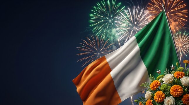 The national flag of ireland waving against a dark night sky filled with colorful bursting fireworks and a bouquet of orange and white flowers in the foreground
