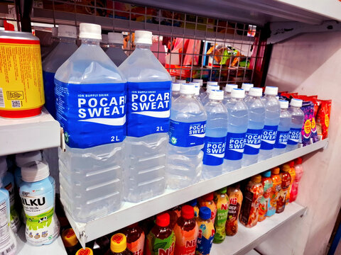 Pocari Sweat electrolyte drinks and flavored milks on retail convenience store shelf on August 17th 2026 in Wonosobo, Indonesia	