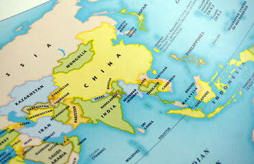 Close up of a colorful world political map focusing on China, India, and Southeast Asia countries. Global geography education, international business and travel atlas background, space for text. © Nungkysoer