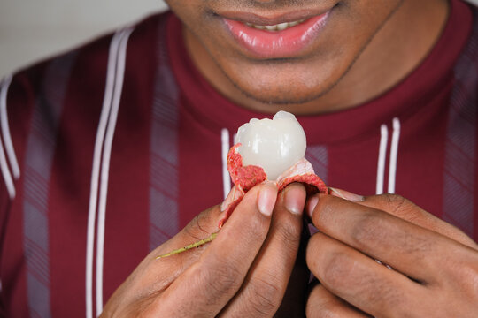 Eating lychee fruit in a home kitchen