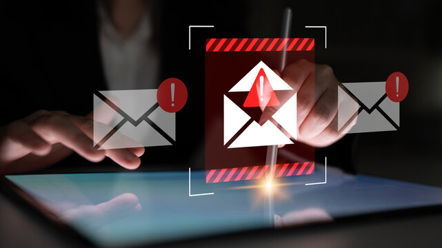 A close-up view of hands interacting with a tablet, displaying a digital alert for a suspicious email, highlighting cybersecurity awareness and the importance of online safety. Gantry