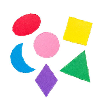Diverse set of colorful torn paper geometric shapes including oval, circle, triangle, crescent, diamond, square.