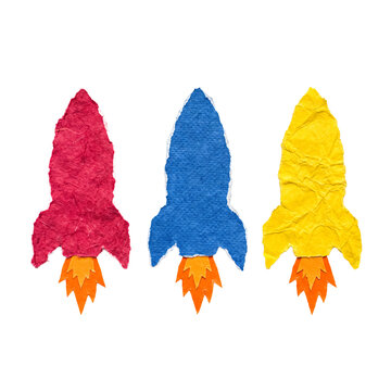 Three vibrant paper craft rockets in red, blue, and yellow, symbolizing startup, innovation, and growth.