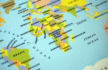 Close up of a colorful world political map focusing on the African continent, Europe, and Atlantic Ocean. Global geography education, travel atlas navigation background, space for text. © Nungkysoer