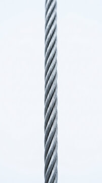 Steel cable vertical close up occupational health safety rope texture minimal industrial background