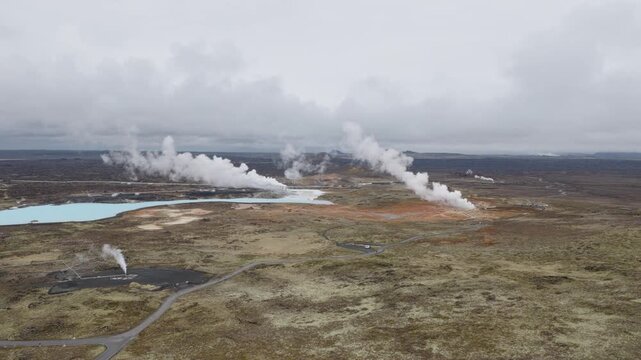 Seltun geothermal field releases multiple steam plumes beside mineral pools and barren volcanic terrain near Route 42, Reykjanes Peninsula, Iceland, slide.