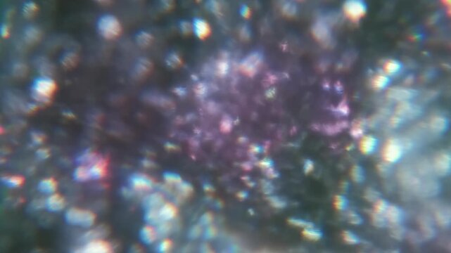 Blur luminous reflection. Bokeh light. Defocused purple silver vibrant radiant glitter texture optical flash on abstract illuminated visual background.