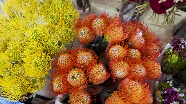 Vibrant Yellow and Orange Pincushion Protea Flowers at Market