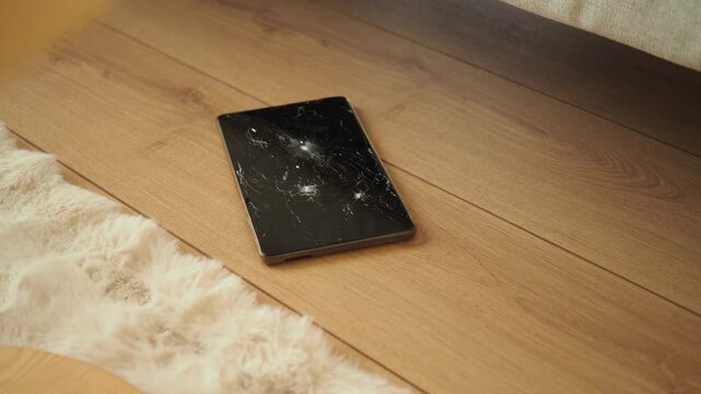 Broken tablet found on wooden floor