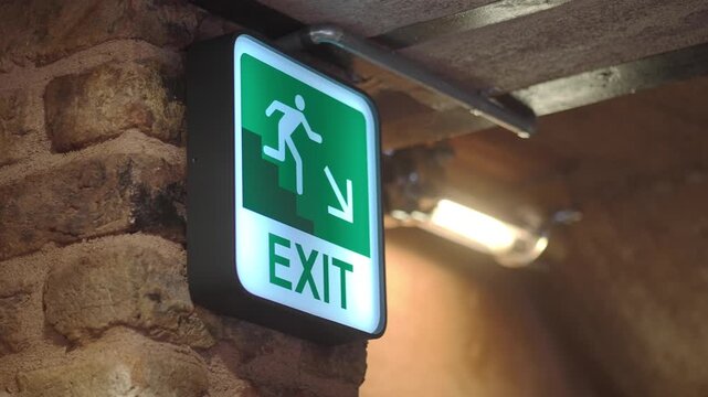Sign showing exit in a building with stairs