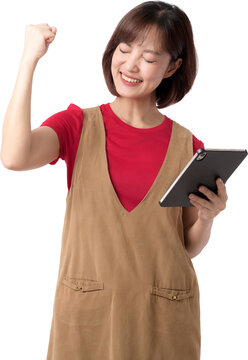 Happy cheerful asian woman holding digital tablet celebrating success with raised fist isolated on transparency background looking excited