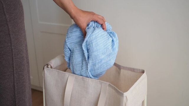 Sorting laundry at home with a blue cloth