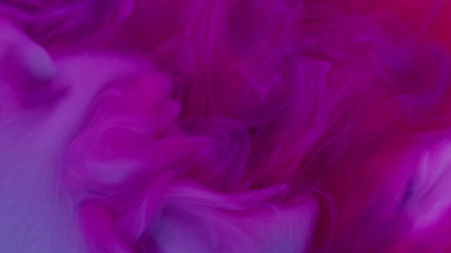 Acrylic smog. Ink flow. Blur pink purple blue colorful cloud splash bright underwater pigment spreading on abstract art background.