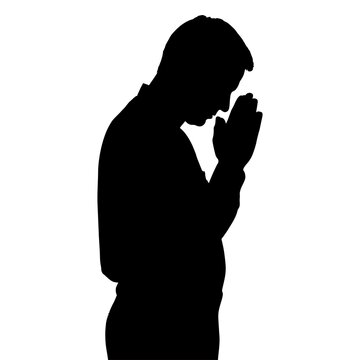 Black silhouette of a man praying WITH HIS HANDS IN THE FIST
