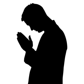 Black silhouette of a man praying WITH HIS HANDS IN THE FIST