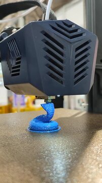 Process printing on 3D printer. The 3D printing process from molten plastic blue color. 3D printing technology. FDM technologies. Fused Deposition Modeling. Additive manufacturing. Vertical