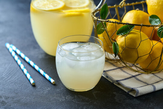 Refreshing homemade summer lemonade. Homemade lemonade  on a dark table. Freshly made lemonade with ice on dark table.