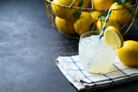 Refreshing homemade summer lemonade. Homemade lemonade  on a dark table. Freshly made lemonade with ice on dark table.