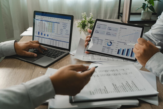 Business team analyzing review financial charts on a laptop reports, comparing figures and reviewing performance data for business analysis, reporting, and financial management.