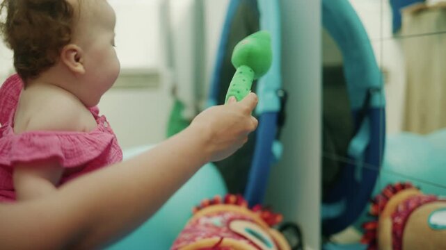 Baby girl with Down syndrome receiving physical therapy, improving motor skills and development in a clinic