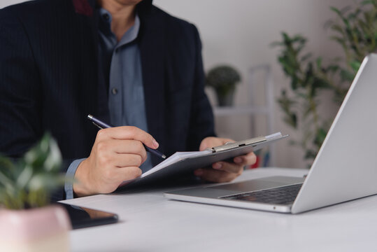 Business Document Review with Clipboard Pen Laptop and Smartphone for Office Administration Paperwork Workflow and Corporate Management