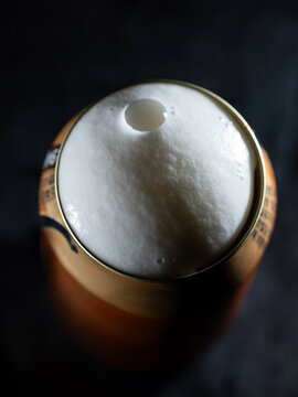 Close-up of draft beer foam on a can