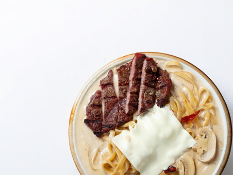 Cream sauce pasta with meat on a plate