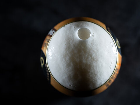 Close-up of draft beer foam on a can