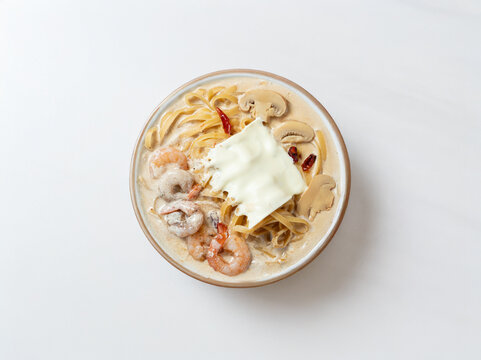 Cream sauce pasta with shrimp on a plate