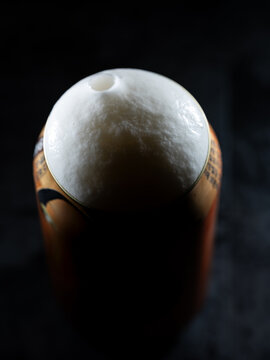 Close-up of draft beer foam on a can