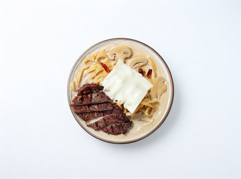 Cream sauce pasta with meat on a plate