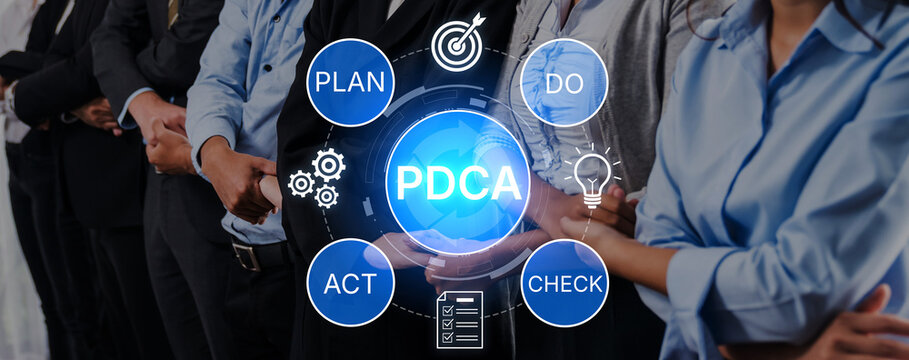 Business Team Engaged in Continuous Improvement Process with PDCA Model in Focus over Meeting Environment. Bitwise.