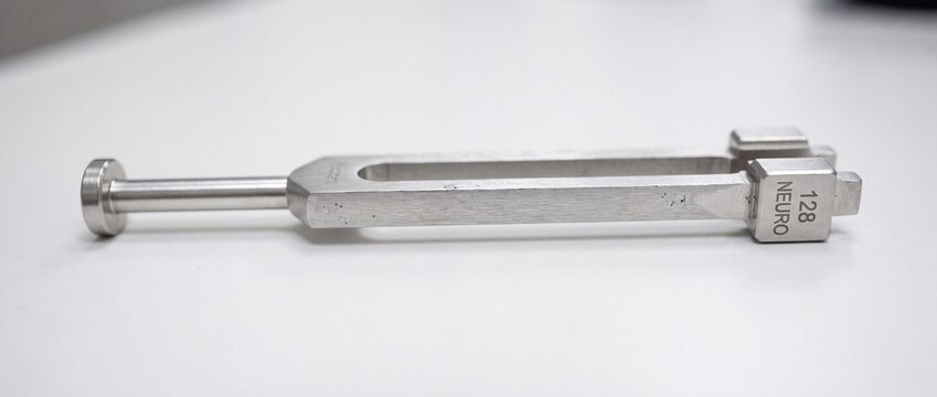 Neurological tuning fork with 128 hertz frequency label for medical diagnostic reflex testing in professional neurological examinations