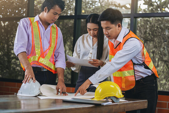 Structural engineer and architect with blueprints discuss and consulting customer, plan working for the house building construction project. Construction collaboration concept. Selected focus