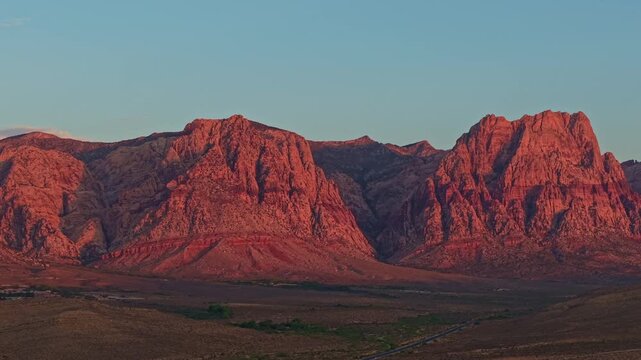 Aerial view of glowing sandstone mountains at sunrise in Red Rock Canyon Nevada