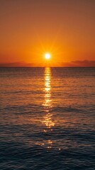 Fototapeta premium Radiant sunrise over calm ocean water creating shimmering golden path reflecting on surface during early morning.