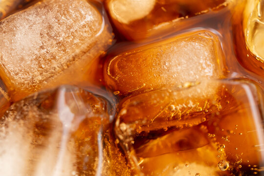 Macro Close Up of cola bubbles and ice cubes background