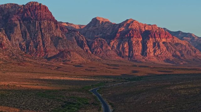 Aerial view of glowing sandstone mountains at sunrise in Red Rock Canyon Nevada