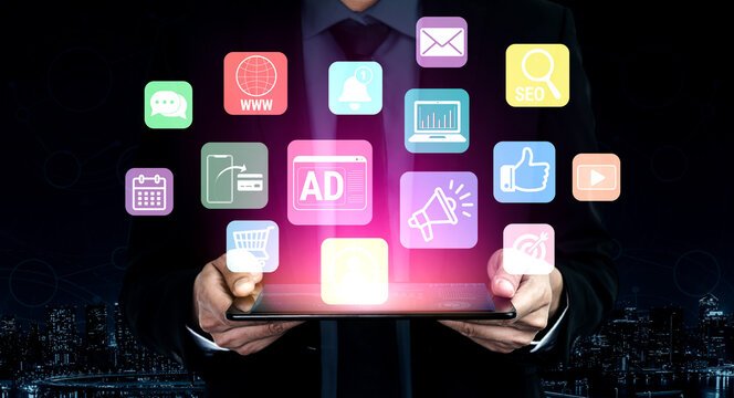 Businessman in Suit Holding Digital Tablet Surrounded by Colorful Marketing Icons and Symbols Representing Technology and Communication in Modern Era Fluxor.