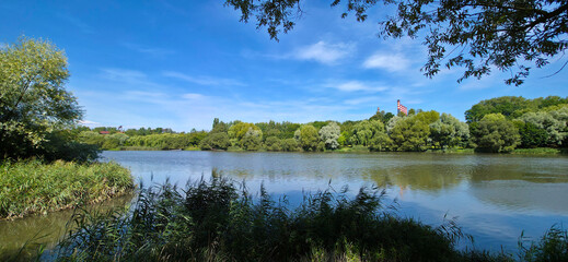 Fototapeta premium Lake in a city park in an industrial area.