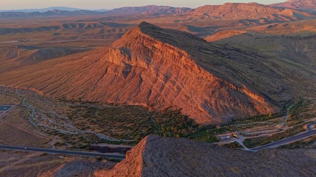 Aerial view of glowing sandstone mountains at sunrise in Red Rock Canyon Nevada