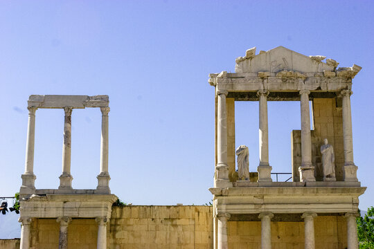 Ancient Roman Theatre in Plovdiv, Bulgaria, with statues and stage lighting.