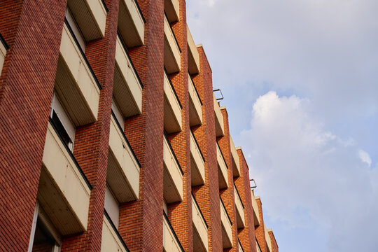 Modern red brick building facade with repeating windows