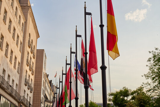 International flags outside urban building on sunny street