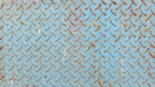 Rusted blue diamond plate metal texture background.