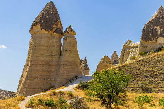 Fairy chimneys in Love Valley, Cappadocia. Hiking adventure and sustainable travel concept.