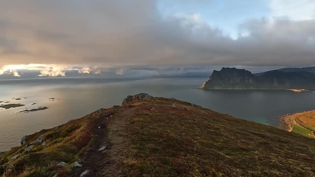 Aerial Drone Shot of Rocky Mountain Ridge at Sunset Over Lofoten Fjord in Norway with Golden Light