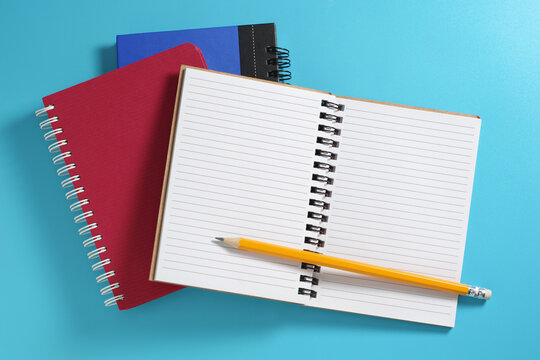 Open Notebook with Yellow Pencil