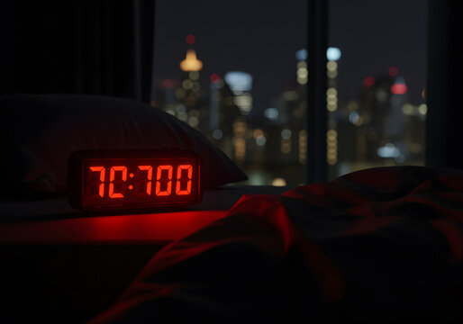 Red digital clock night skyline
